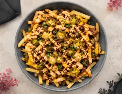 Loaded fries topped with cheese, chicken and jalapenos